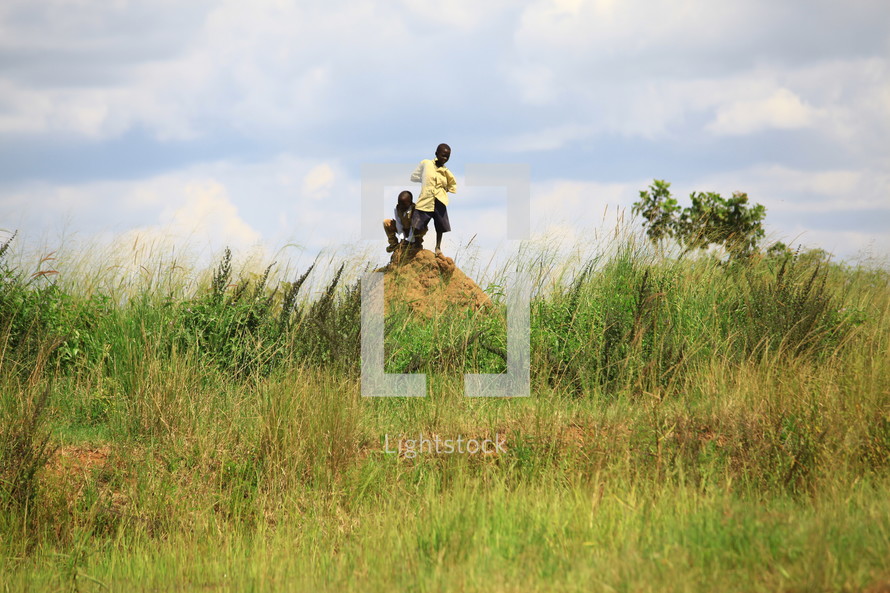 African boys on dirt mound