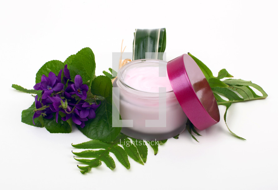face cream with green leaves isolated on white background
