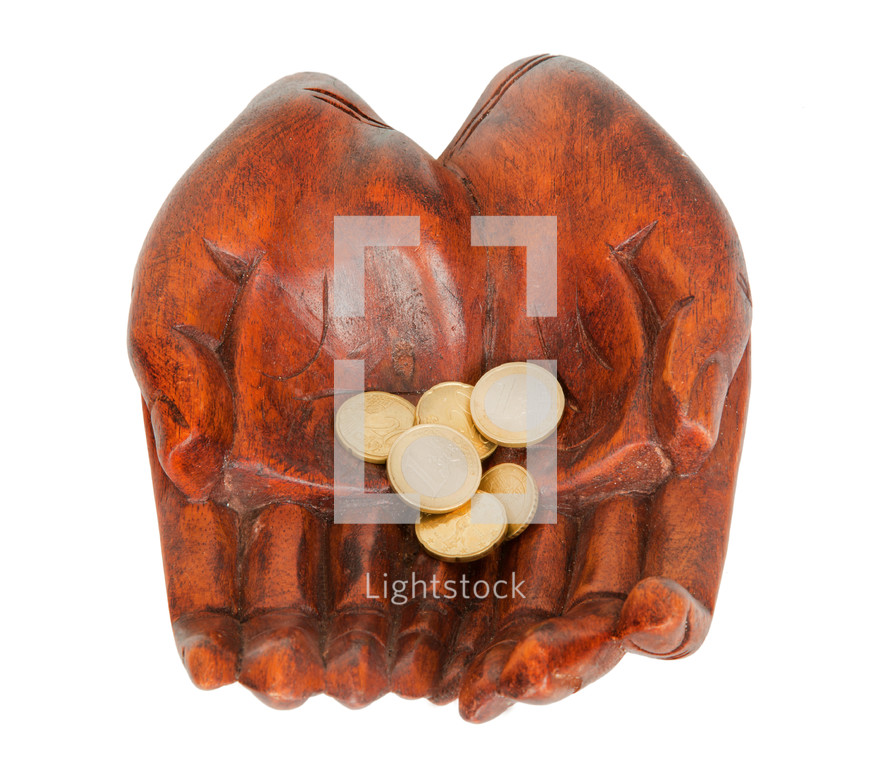 wooden carved hands holding coins 