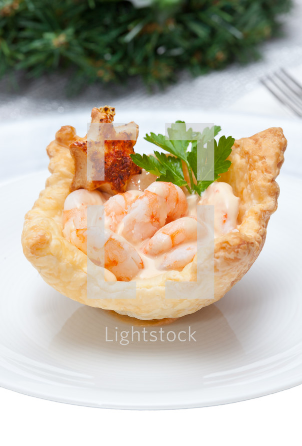 Shrimp cocktail in the puff pastry on christmas table.