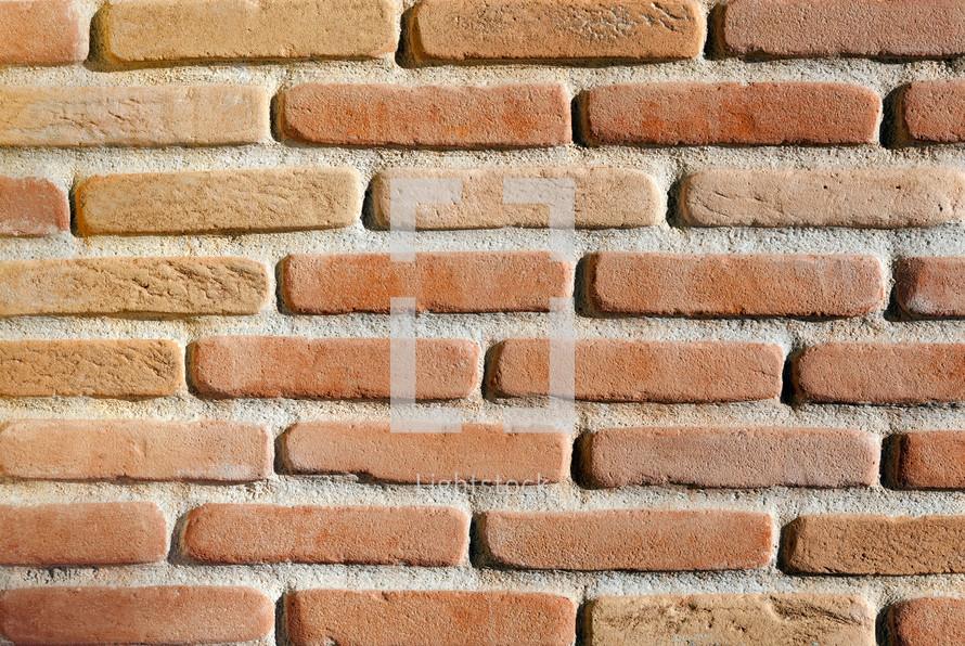 Modern red brick wall background with cracks in concrete