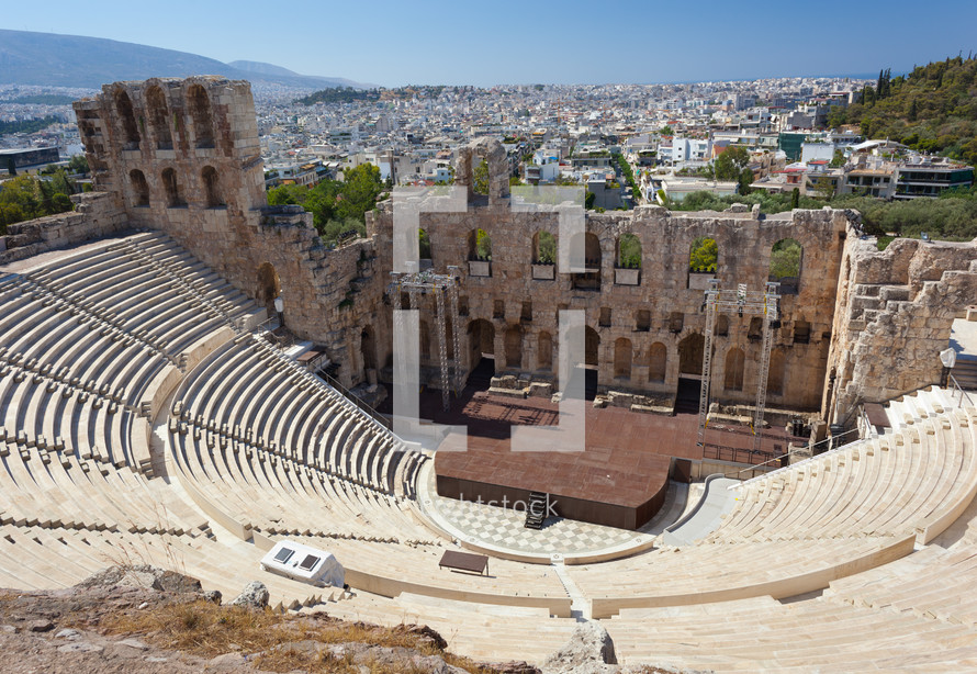The Odeon of Herodes Atticus with the city of athens is in the background