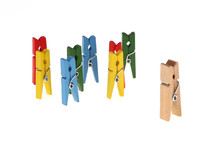 Wooden clothespins colored to represent a metaphorical concept of people on white