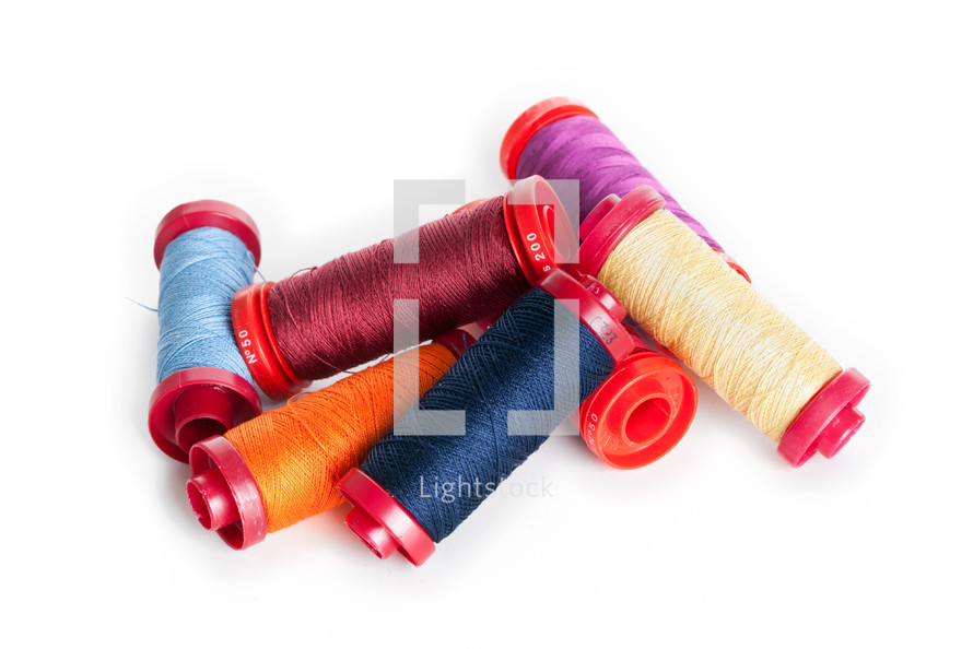 Bobbins of thread isolated on white background.