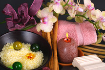 spa accessories with orchid flowers on black background