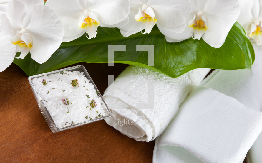 Spa accessories with orchid flowers on wooden table