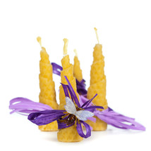 Four beeswax candles on white background