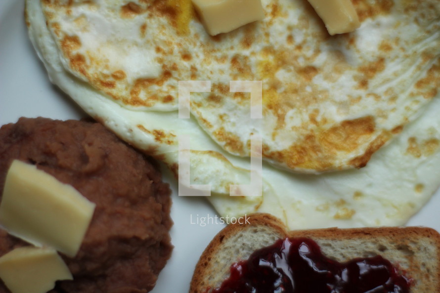 refried beans, eggs, and jam on toast 