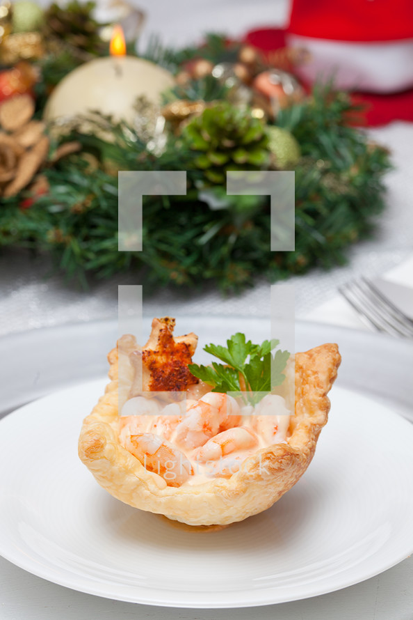Shrimp cocktail in the puff pastry on christmas table.