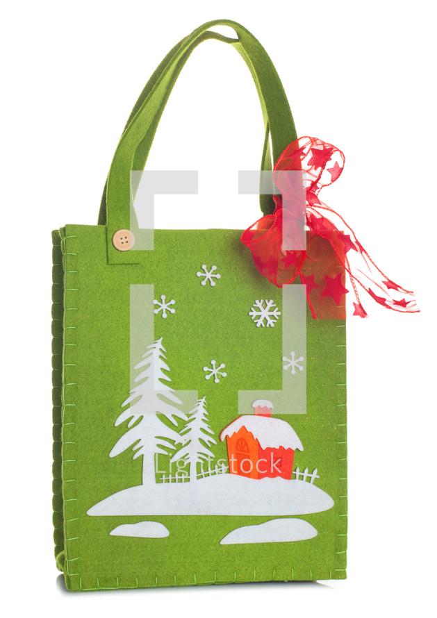 Cloth bag with Christmas decorations on white background