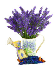 Watering can with lavender sachet on white background 