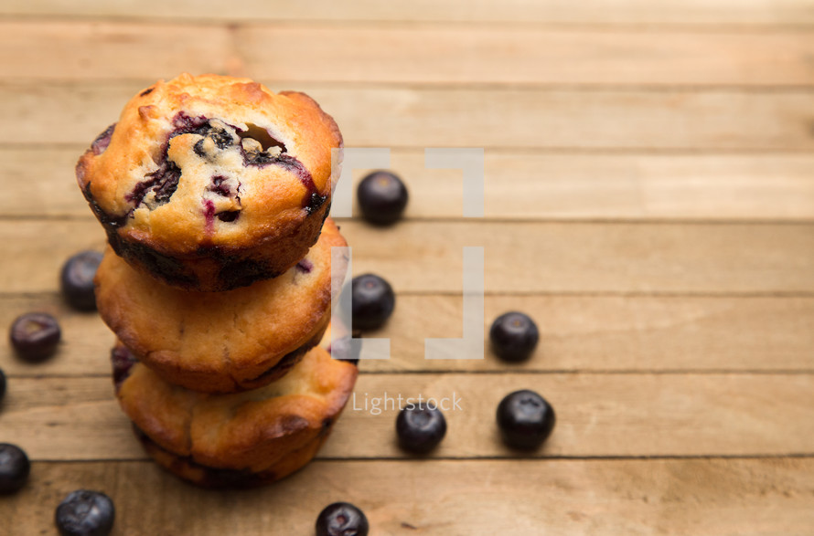 blueberry muffins on a wood background 