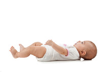 baby on a white background lying on her back 