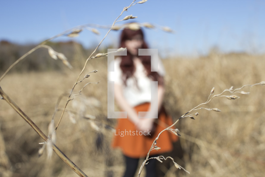 woman standing in a field of wheat 