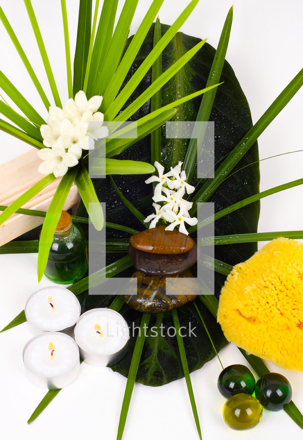 Accessories for spa with flowers of jasmine on white background