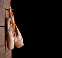 ballet shoes hanging on a hook 