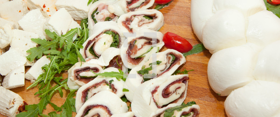 Roll with tomato mozzarella cheese raw ham.