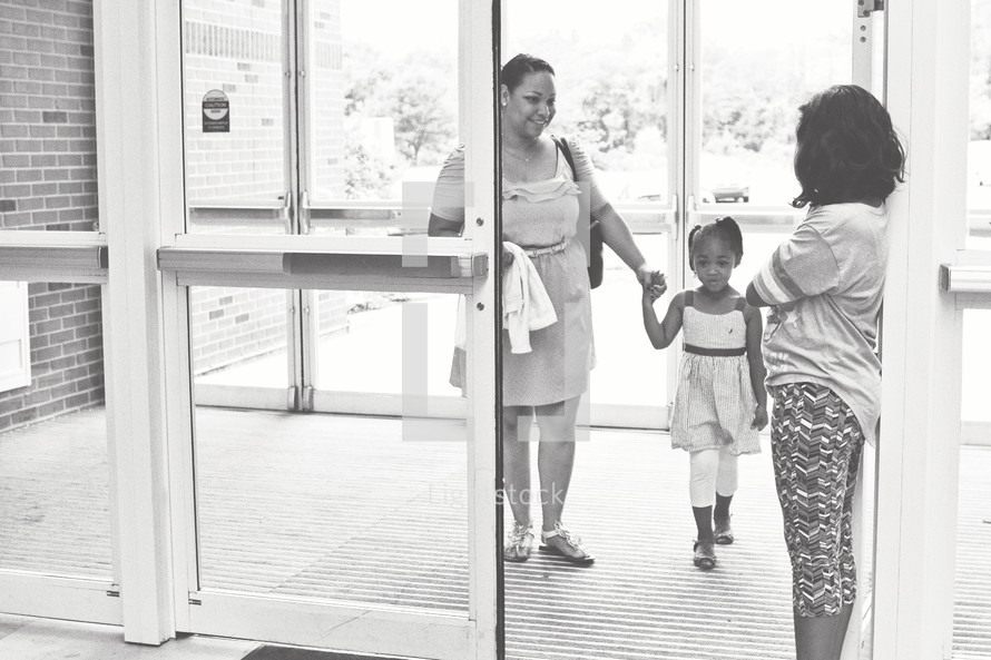 greeter welcoming a mother and daughter 