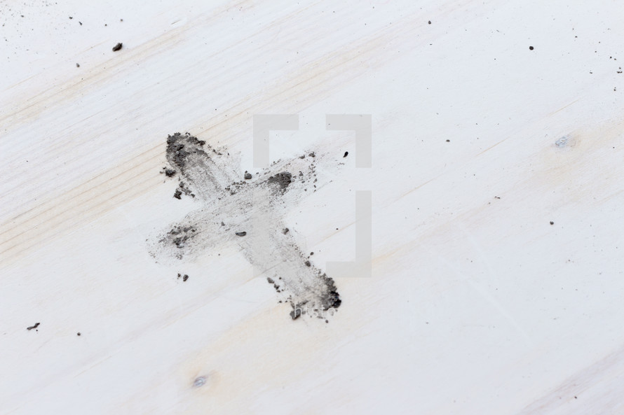 cross from ashes on white wood 