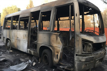 Charred shell of a bus after a severe fire incident