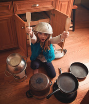 a child playing with pots and pans 