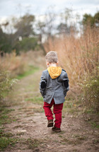 toddler boy walking outdoors 
