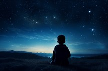 Back view of a child sitting alone, looking at a vast starry sky above