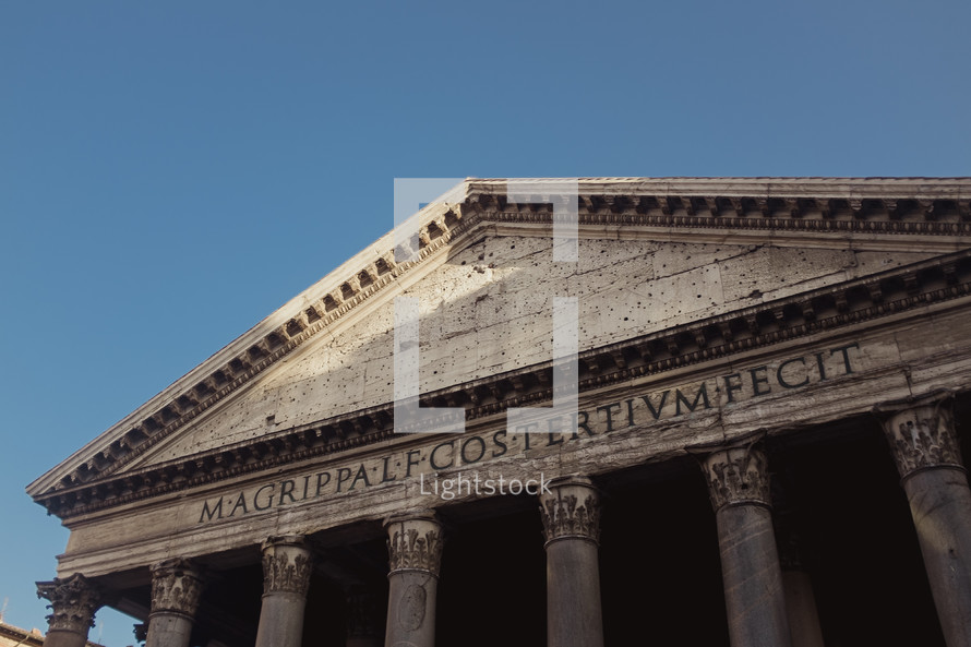columns and roof of a historical building in Rome 