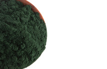 A Wooden Bowl Full of Spirulina Powder on a White Background