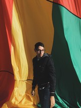 man and a red, yellow, and green parachute  