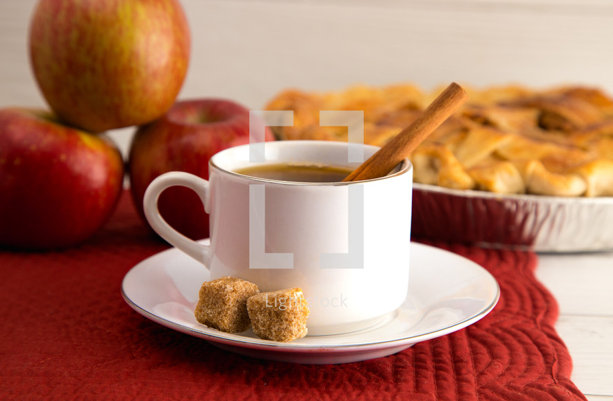 Hot Apple Cider with an Apple Pie and Cinnamon Stick