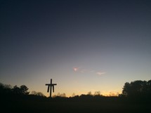 silhouette of a cross under a cloudy sky, shroud