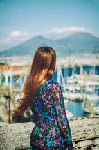 Tourist is admiring the cityscape of naples with mount vesuvius in the background