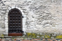 arched door on stone wall 