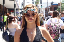 A young woman in a headband and sunglasses.