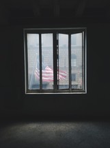 view of an American flag flying through a window 