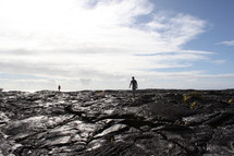 a man walking on volcanic ash