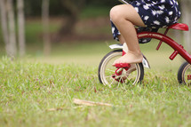 child riding a tricycle 