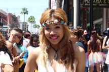 A young woman in a headband on a crowded street.