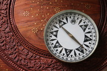 Magnetic compass on oriental wooden desk