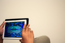 a man playing video games on a tablet 