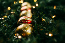 gold ornaments, pine garland, Christmas lights