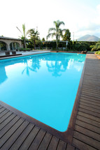 swimming pool with treck wood flooring.
