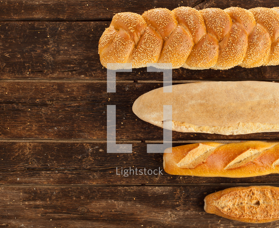 Variety types of bread on wood table.