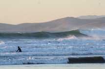Surfer on surfboard in ocean waves