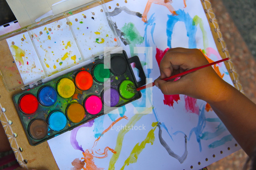 child painting with watercolors 