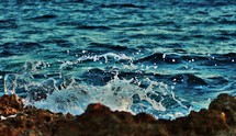 sea water splashing into rocks 