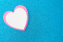 pink and white heart on blue 
