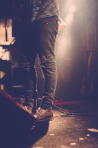 feet of a man on stage