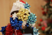 Child covered with Christmas decorations.